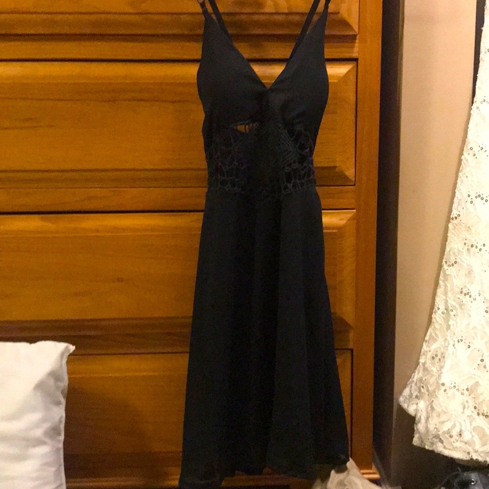 Short black dress with a lace look.